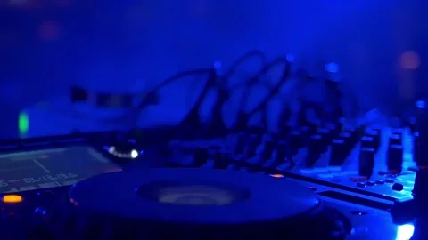 DJ playing table mixer at night club party Stock Footage 255680837
