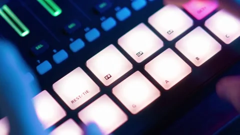 DJ Plays Beat Sampler with Color Drum Pads and Samples in Studio Environment Stock Footage 163054309