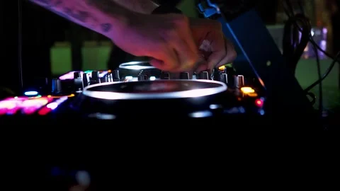 DJ plays live set and mixing music on turntable console in the night club. Stock Footage 221716199