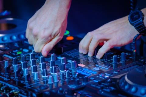 DJ plays mix on controller at a disco Stock Photos
