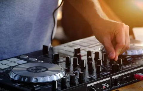 DJ plays on the mixing console. Stock Photos