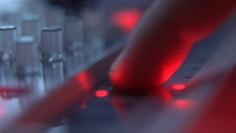 A DJ plays music at the console Stock Footage 128691885