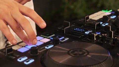 DJ Plays Music Using DJ Mixing Controller at Night Party Stock Footage 248315349