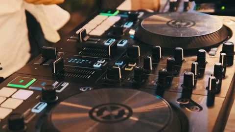 DJ Plays Music Using DJ Mixing Controller at Night Party Stock Footage 250186677