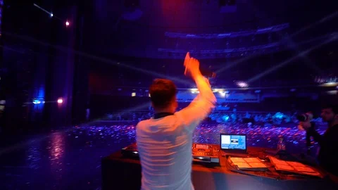 DJ plays at the remote control in the cool disco club Stock Footage 128271464