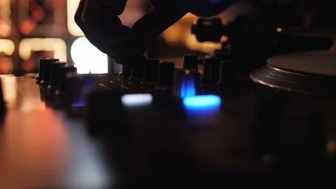 DJ plays vinyl turntables. In a nightclub - bar. The vinyl record is spinning Stock Footage