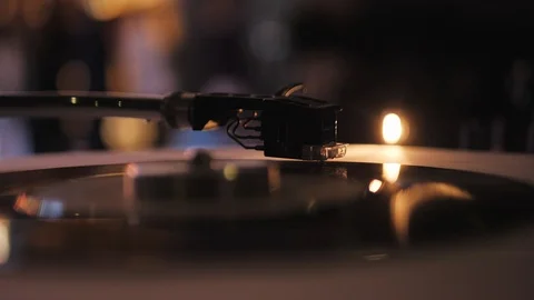 DJ plays vinyl turntables. In a nightclub - bar. The vinyl record is spinning Stock Footage