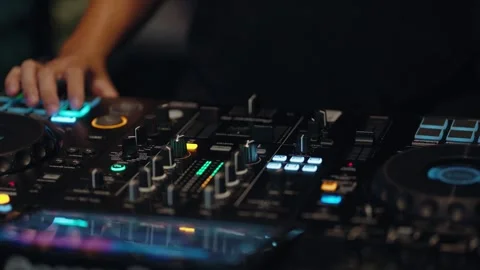DJ practicing music mixing on a professional controller in a studio Vídeo Stock 342926817