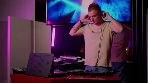 DJ put on headphones and continue play music in club indoor Stock Footage 201484393