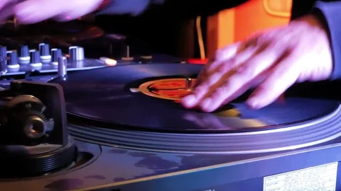 DJ puts a new record on the turntable Stock Footage 77092785