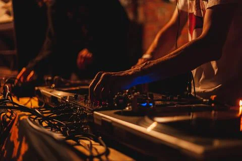 DJ remote control with a vinyl player for playing electronic music in a night 스톡 사진