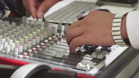 The DJ s hands touch the buttons and sliders that play electronic music. A Stock Footage 132719018