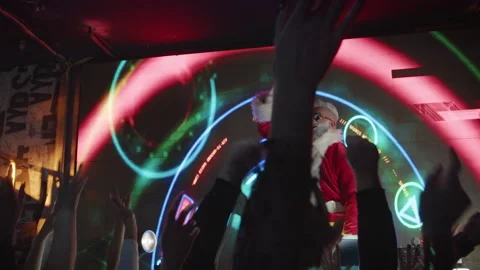 DJ Santa Claus playing music at nightclub and enjoying great festival party. Stock Footage