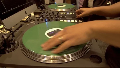 DJ Scratching on Mixing Console at Trade Show Stock Footage 104884468