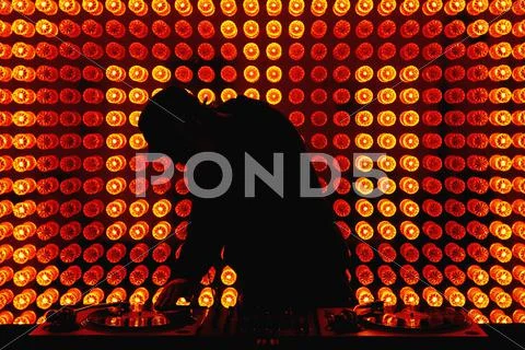 A DJ scratching a record in a nightclub Stock Photos