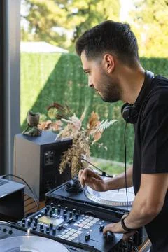 DJ setting up the mixing console before starting the concert Stock Photos