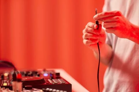 DJ setup closeup, Close view of audio connection process during live performance Stock Photos