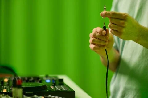 DJ setup closeup, Close view of audio connection process during live performance Stock Photos