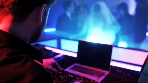 DJ Sitting in Front of the DJ Console Seen from the Side. Wedding party Stock Footage 71813322