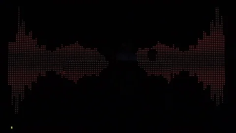 Dj sitting in front of a lighted panel that change images, while it mi Stock Footage 69833584