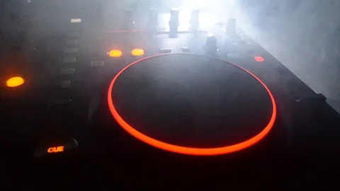 DJ Spinning, Mixing, and Scratching in a Night Club, strobe lights and fog Stock Footage