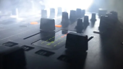 DJ Spinning, Mixing, and Scratching in a Night Club, strobe lights and fog Stock Footage