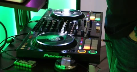 DJ standing behind turntable Stock Footage 220873677