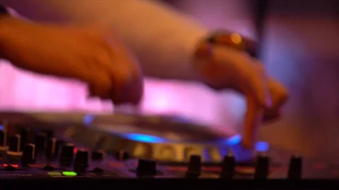 DJ stands behind the mixer Stock Footage 107650339
