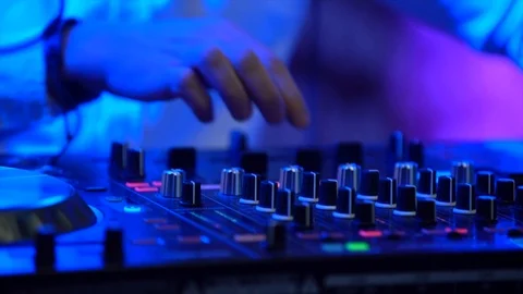DJ stands behind the mixer,  Stock Footage 107650370