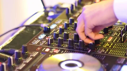 DJ turning knobs on DJ board Stock Footage 97816579