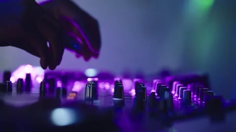 DJ turning the knobs of the musical instrument 4K Slow motion Stock Footage 257519525