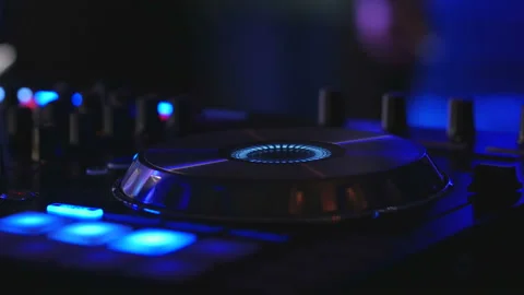DJ turning knobs on professional mixer console and playing music in nightclub Video stock 86792501
