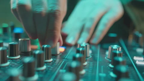 DJ turns knobs on audio console in nightclub closeup Video stock 271120202