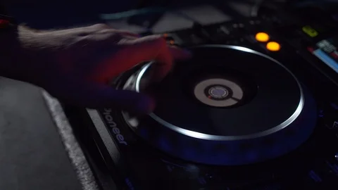 DJ twists the jog wheels on the controller. Scratching. Stock Footage 122153488