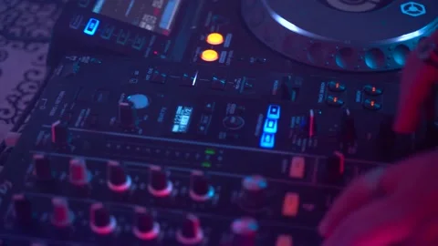 Dj uses Mixing Controller, stroboscopic light and smoke, gimbal shot Stock Footage 152425434