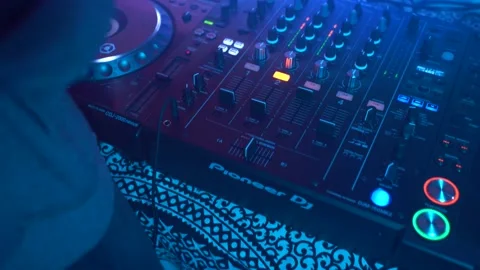 Dj uses Mixing Controller, stroboscopic light and smoke, gimbal shot Stock Footage 152425500