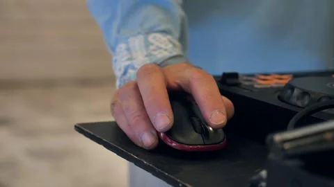 DJ using a computer mouse near mixing controller at a party Stock Footage 344073345