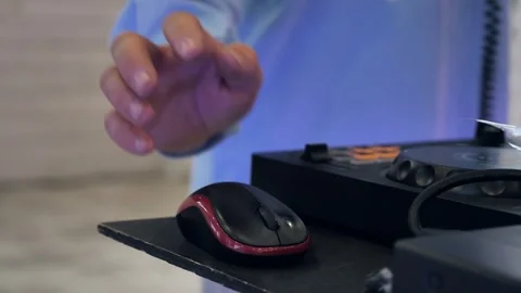 DJ using a computer mouse near mixing controller at a party Stock Footage 344073353