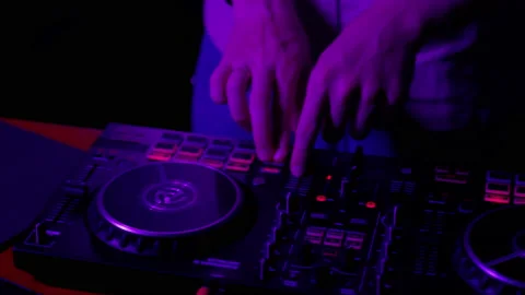 DJ using console in club in neon lights close up Stock Footage 201482416