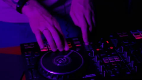 DJ using console in club in neon lights close up Stock Footage 201483437