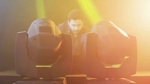 DJ Using Head Spots Which Give Light in Different Colors Stock Footage 71811853