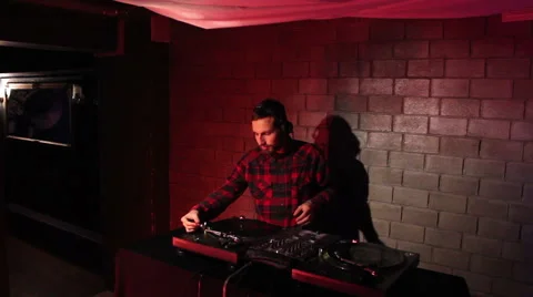DJ using his mixer and  turntable Stock Footage 43478931