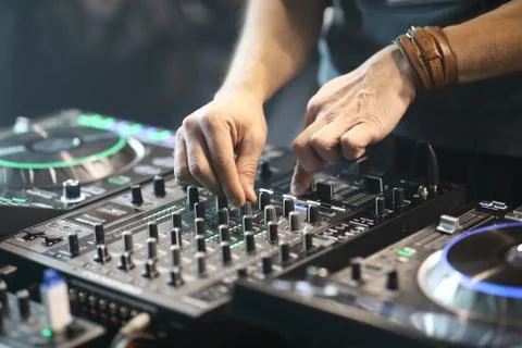 DJ using sound controller to mix music Stock Photos