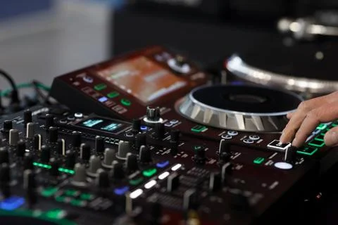 DJ using a sound mixer controller to play music Foto stock