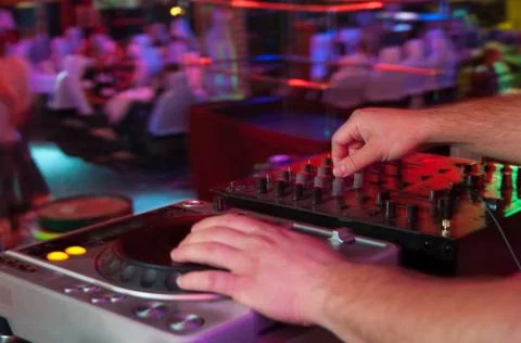 DJ at work, disco party Close-up of human hand spinning turntable with gro... Stock Photos