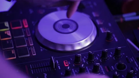 Dj at work. Hands of DJ tweak various track controls on dj's deck Stock Footage 142884735