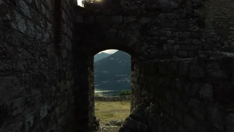 DJI 0003 Drone going out from an old ruined medieval castle and the beautifu Stock Footage 156817628