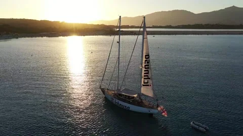 DJI 0202 - Ichnusa beer boat on sunset- Sardinia Stock Footage