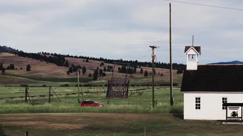DJI Air 3 Drone Shot Car driving Bitterroot Valley Montana Autumn Colors Graded Stock Footage 255087341