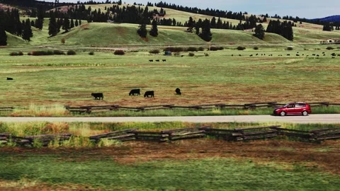 DJI Air 3 Drone Shot Car driving Bitterroot Valley Montana Autumn Colors Graded Stock Footage 255088043